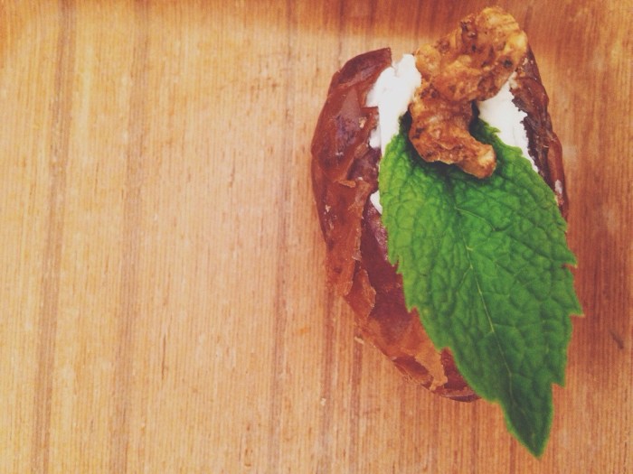 date stuffed with goat cheese and topped with fresh mint and toasted walnut