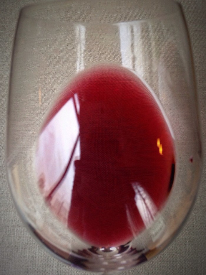 note the light-bodied color, a garnet red