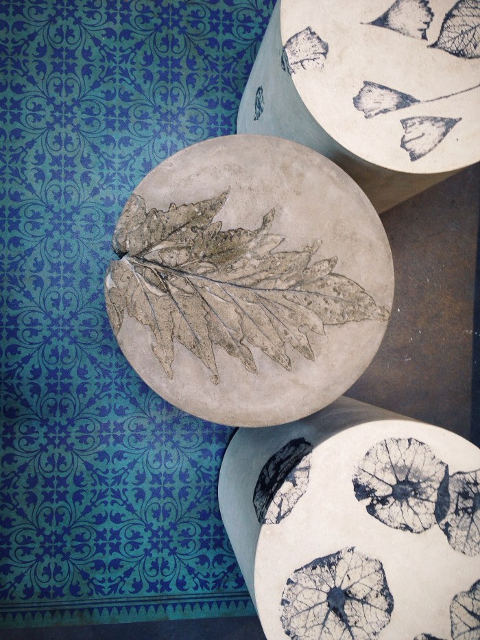 Concrete side tables with fossilized beauties built in.
