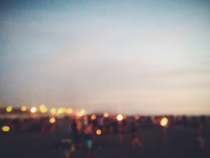 The haze of bonfires on the beach at dusk